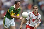 26 September 2004; Anthony Maher, Kerry, in action against John Gilmore, Tyrone. All-Ireland Minor Football Championship Final, Kerry v Tyrone, Croke Park, Dublin. Picture credit; Ray McManus / SPORTSFILE *** Local Caption *** Any photograph taken by SPORTSFILE during, or in connection with, the 2004 All-Ireland Minor Football Final which displays GAA logos or contains an image or part of an image of any GAA intellectual property, or, which contains images of a GAA player/players in their playing uniforms, may only be used for editorial and non-advertising purposes.  Use of photographs for advertising, as posters or for purchase separately is strictly prohibited unless prior written approval has been obtained from the Gaelic Athletic Association.