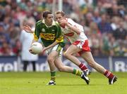 26 September 2004; Brian Looney, Kerry, in action against John Gilmore, Tyrone. All-Ireland Minor Football Championship Final, Kerry v Tyrone, Croke Park, Dublin. Picture credit; Ray McManus / SPORTSFILE *** Local Caption *** Any photograph taken by SPORTSFILE during, or in connection with, the 2004 All-Ireland Minor Football Final which displays GAA logos or contains an image or part of an image of any GAA intellectual property, or, which contains images of a GAA player/players in their playing uniforms, may only be used for editorial and non-advertising purposes.  Use of photographs for advertising, as posters or for purchase separately is strictly prohibited unless prior written approval has been obtained from the Gaelic Athletic Association.