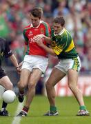 26 September 2004; Ronan McGarrity, Mayo, in action against Eoin Brosnan, Kerry. Bank of Ireland All-Ireland Senior Football Championship Final, Kerry v Mayo, Croke Park, Dublin. Picture credit; Ray McManus / SPORTSFILE *** Local Caption *** Any photograph taken by SPORTSFILE during, or in connection with, the 2004 Bank of Ireland All-Ireland Senior Football Final which displays GAA logos or contains an image or part of an image of any GAA intellectual property, or, which contains images of a GAA player/players in their playing uniforms, may only be used for editorial and non-advertising purposes.  Use of photographs for advertising, as posters or for purchase separately is strictly prohibited unless prior written approval has been obtained from the Gaelic Athletic Association.