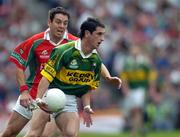 26 September 2004; Paul Galvin, Kerry, in action against Fergal Kelly, Mayo. Bank of Ireland All-Ireland Senior Football Championship Final, Kerry v Mayo, Croke Park, Dublin. Picture credit; Ray McManus / SPORTSFILE *** Local Caption *** Any photograph taken by SPORTSFILE during, or in connection with, the 2004 Bank of Ireland All-Ireland Senior Football Final which displays GAA logos or contains an image or part of an image of any GAA intellectual property, or, which contains images of a GAA player/players in their playing uniforms, may only be used for editorial and non-advertising purposes.  Use of photographs for advertising, as posters or for purchase separately is strictly prohibited unless prior written approval has been obtained from the Gaelic Athletic Association.