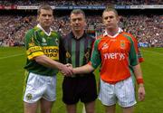 26 September 2004; Kerry captain Dara O Cinneide shakes hands with Mayo captain Gary Ruane in the presence of referee Pat McEnaney. Bank of Ireland All-Ireland Senior Football Championship Final, Kerry v Mayo, Croke Park, Dublin. Picture credit; Ray McManus / SPORTSFILE *** Local Caption *** Any photograph taken by SPORTSFILE during, or in connection with, the 2004 Bank of Ireland All-Ireland Senior Football Final which displays GAA logos or contains an image or part of an image of any GAA intellectual property, or, which contains images of a GAA player/players in their playing uniforms, may only be used for editorial and non-advertising purposes.  Use of photographs for advertising, as posters or for purchase separately is strictly prohibited unless prior written approval has been obtained from the Gaelic Athletic Association.