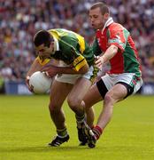 26 September 2004; Tom O'Sullivan, Kerry, in action against Trevor Mortimer, Mayo. Bank of Ireland All-Ireland Senior Football Championship Final, Kerry v Mayo, Croke Park, Dublin. Picture credit; Ray McManus / SPORTSFILE *** Local Caption *** Any photograph taken by SPORTSFILE during, or in connection with, the 2004 Bank of Ireland All-Ireland Senior Football Final which displays GAA logos or contains an image or part of an image of any GAA intellectual property, or, which contains images of a GAA player/players in their playing uniforms, may only be used for editorial and non-advertising purposes.  Use of photographs for advertising, as posters or for purchase separately is strictly prohibited unless prior written approval has been obtained from the Gaelic Athletic Association.