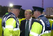 8 October 2004 Shamrock Rovers Event Controller Richard Tully consults members of the Gardai during a peaceful protest by Shamrock Rovers fans. eircom league, Premier Division, Shamrock Rovers v Derry City, Richmond Park, Dublin. Picture credit; Brian Lawless / SPORTSFILE