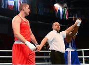 19 October 2013; Yohandi Ortega, right, Cuba, is declared the winner over Con Sheehan, Clonmel BC, Tipperary, representing Ireland, after their Men's Super Heavyweight +91Kg Last 32 bout. AIBA World Boxing Championships Almaty 2013, Almaty, Kazakhstan. Photo by Sportsfile