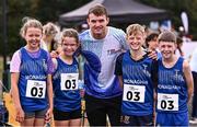 23 August 2025; Olympian Marcus Lawler with runners from Tyholland in Monaghan from left, Lexie Ronaghan, Grace Farrelly, Aaron Rooney, Eli Mohan at the 2025 Cairn Community Games National Track, Field and Relay Finals at SETU Running Track and Field in Carlow. Photo by Piaras Ó Mídheach/Sportsfile