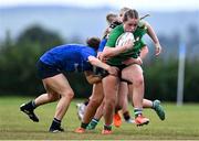 26 August 2025; Aoibheann Ryan of South East is tackled by Saffron Adams, left, and Amélie O'Toole-Drieux of North Midlands during the BearingPoint Sarah Robinson Cup Round 1 match between South East and North Midlands at SETU in Carlow. Photo by Ben McShane/Sportsfile