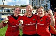 30 August 2025; Munster players, from left, Clodagh O'Halloran, Chloe Pearse and Deirbhile Nic a Bháird celebrate after the Vodafone Women’s Interprovincial Championship final match between Leinster and Munster at Energia Park in Dublin. Photo by Tyler Miller/Sportsfile