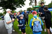 3 September 2025; Tipperary All-Ireland Hurling winning Captain Ronan Maher, left, and Kerry gaelic footballer David Clifford sign autographs for supporters during the Pro AM ahead of the Amgen Irish Open Golf Championship 2025 at The K Club in Straffan, Kildare. Photo by Ramsey Cardy/Sportsfile