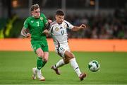 6 September 2025; Milos Kerkez of Hungary in action against Sammie Szmodics of Republic of Ireland during the FIFA World Cup 2026 Group F qualifying match between Republic of Ireland and Hungary at the Aviva Stadium in Dublin. Photo by David Fitzgerald/Sportsfile