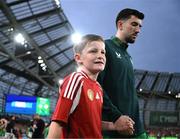 6 September 2025; Finn Azaz of Republic of Ireland and his mascot walk out for the FIFA World Cup 2026 Group F qualifying match between Republic of Ireland and Hungary at the Aviva Stadium in Dublin. Photo by Stephen McCarthy/Sportsfile