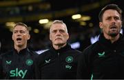 6 September 2025; Republic of Ireland goalkeeping coach Gudmundur Hreidarsson, centre, assistant coach Paddy McCarthy, right, and head of athletic performance Damien Doyle, left, stand for the playing of the National Anthem  before the FIFA World Cup 2026 Group F qualifying match between Republic of Ireland and Hungary at the Aviva Stadium in Dublin. Photo by Stephen McCarthy/Sportsfile