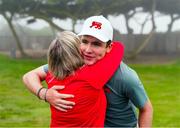 7 September 2025; Gavin Tiernan of Great Britain and Ireland golfer gets a hug from his mother after winning his match on the 17th hole during the afternoon singles matches of day two of the 50th Walker Cup at Cypress Point Club in California, USA. Photo by Brian Spurlock/Sportsfile