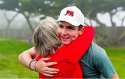 7 September 2025; Gavin Tiernan of Great Britain and Ireland golfer gets a hug from his mother after winning his match on the 17th hole during the afternoon singles matches of day two of the 50th Walker Cup at Cypress Point Club in California, USA. Photo by Brian Spurlock/Sportsfile