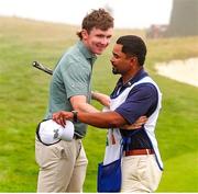 7 September 2025; Gavin Tiernan of Great Britain and Ireland gets a hug from his caddy after winning his match on the 17th hole during the afternoon singles matches of day two of the 50th Walker Cup at Cypress Point Club in California, USA. Photo by Brian Spurlock/Sportsfile