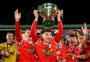 13 September 2025; Daniel Mare of Shelbourne lifts the cup after his side's victory in the EA SPORTS MU20 LOI Enda McGuill Cup match between Shelbourne and UCD at Carlisle Grounds in Bray, Wicklow. Photo by Shauna Clinton/Sportsfile