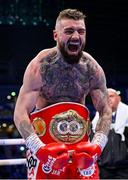 13 September 2025; Lewis Crocker celebrates defeating Paddy Donovan in their IBF World Welterweight title bout at Clearer Twist National Football Stadium at Windsor Park in Belfast. Photo by Ramsey Cardy/Sportsfile