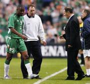 9 October 2004; Clinton Morrison, Republic of Ireland, is helped off the pitch by team physio Ciaran Murray and greeted by manager Brian Kerr after an injury forced him to be substituted during the first half. France. FIFA World Cup 2006 Qualifier, France v Republic of Ireland, Stade de France, Paris, France. Picture credit; David Maher / SPORTSFILE