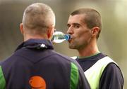 12 October 2004; Roy Keane, Republic of Ireland, takes a drink of water during squad training as team-mate Graham Kavanagh looks on. Lansdowne Road, Dublin. Picture credit; David Maher / SPORTSFILE