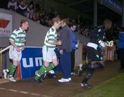 8 October 2004; Shamrock Rovers players, from right, Russell Payne, goalkeeper, Steven Gough and Trevor Molloy make their way onto the pitch before the match. Fans entered the pitch just before kick-off to perform a peaceful protest. eircom league, Premier Division, Shamrock Rovers v Derry City, Richmond Park, Dublin. Picture credit; Brian Lawless / SPORTSFILE