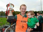 20 October 2013; Glenswilly manager Gary McDaid celebrates with the cup with his 21 month old daughter Meghan. Donegal County Senior Club Football Championship Final, Glenswilly v Killybegs, MacCumhaill Park, Ballybofey, Co. Donegal. Picture credit: David Maher / SPORTSFILE