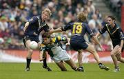 17 October 2004; Setanta O hAilpin, Ireland, in action against Craig Bolton, left, Joel Corey (19) and Brad Rawlings, Australia. Coca Cola International Rules Series 2004, First Test, Ireland v Australia, Croke Park, Dublin. Picture credit; Brendan Moran / SPORTSFILE *** Local Caption *** Any photograph taken by SPORTSFILE during, or in connection with, the 2004 Coca Cola International Rules Series which displays GAA logos or contains an image or part of an image of any GAA intellectual property, or, which contains images of a GAA player/players in their playing uniforms, may only be used for editorial and non-advertising purposes.  Use of photographs for advertising, as posters or for purchase separately is strictly prohibited unless prior written approval has been obtained from the Gaelic Athletic Association.