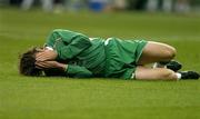 9 October 2004; Kevin Kilbane, Republic of Ireland, holds his face after being tackled. FIFA World Cup 2006 Qualifier, France v Republic of Ireland, Stade de France, Paris, France. Picture credit; Brendan Moran / SPORTSFILE
