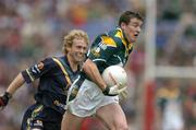 17 October 2004; Ciaran McManus, Ireland, in action against Craig Bolton, Australia. Coca Cola International Rules Series 2004, First Test, Ireland v Australia, Croke Park, Dublin. Picture credit; Brendan Moran / SPORTSFILE *** Local Caption *** Any photograph taken by SPORTSFILE during, or in connection with, the 2004 Coca Cola International Rules Series which displays GAA logos or contains an image or part of an image of any GAA intellectual property, or, which contains images of a GAA player/players in their playing uniforms, may only be used for editorial and non-advertising purposes.  Use of photographs for advertising, as posters or for purchase separately is strictly prohibited unless prior written approval has been obtained from the Gaelic Athletic Association.