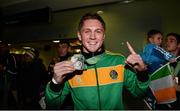 27 October 2013; Ireland's Jason Quigley, from Finn Valley BC, Donegal, with his AIBA World Boxing Championships silver medal on his arrival home from the AIBA World Boxing Championships Almaty 2013 in Kazakhstan. Dublin Airport, Dublin. Photo by Sportsfile