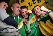 27 October 2013; Ireland's Jason Quigley, from Finn Valley BC, Donegal, with his AIBA World Boxing Championships silver medal, centre, is congratulated by supporters, on his arrival home from the AIBA World Boxing Championships Almaty 2013 in Kazakhstan. Dublin Airport, Dublin. Photo by Sportsfile