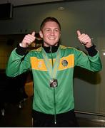 27 October 2013; Ireland's Jason Quigley, from Finn Valley BC, Donegal, with his AIBA World Boxing Championships silver medal on his arrival home from the AIBA World Boxing Championships Almaty 2013 in Kazakhstan. Dublin Airport, Dublin. Photo by Sportsfile