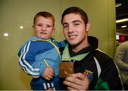 27 October 2013; Ireland's Joe Ward, from Moate BC, Co. Westmeath, with his two year old son Joe and bronze medal on his arrival home from the AIBA World Boxing Championships Almaty 2013 in Kazakhstan. Dublin Airport, Dublin. Photo by Sportsfile