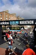 25 October 2004; Runners pass the finish line. adidas Dublin City Marathon 2004. Merrion Square, Dublin. Picture credit; Brendan Moran / SPORTSFILE