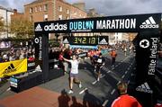 25 October 2004; Runners cross the finish line. adidas Dublin City Marathon 2004. Merrion Square, Dublin. Picture credit; Brendan Moran / SPORTSFILE
