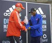 25 October 2004; Tseko Mpolokeng, of South Africa, who finished second, is presented with a piece of crystal by Race Director Jim Aughney. adidas Dublin City Marathon 2004. Merrion Square, Dublin. Picture credit; Brendan Moran / SPORTSFILE