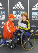 25 October 2004; Winner of the Wheelchair race, Emer Patten, is presented with a piece of crystal by Race Director Jim Aughney. adidas Dublin City Marathon 2004. Merrion Square, Dublin. Picture credit; Brendan Moran / SPORTSFILE