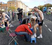 25 October 2004; Runners have the electronic timing chips removed from their trainers on completion of the race. adidas Dublin City Marathon 2004. Merrion Square, Dublin. Picture credit; Brendan Moran / SPORTSFILE