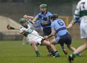 31 October 2004; Brian McCormack, Portlaoise, in action against Eamon Ryan, 6, and Bryan Barry, UCD. AIB Leinster Club Hurling Championship, Portlaoise v UCD, O'Moore Park, Portlaoise, Co. Laois. Picture credit; Ray McManus / SPORTSFILE