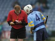 31 October 2004; Robert Kirwan, UCD, is booked by referee Fergus Smith. AIB Leinster Club Hurling Championship, Portlaoise v UCD, O'Moore Park, Portlaoise, Co. Laois. Picture credit; Ray McManus / SPORTSFILE