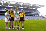 1 November 2004; Anne Morgan, Liatroim Fontenoy, Down, left, Cait Kenny, Four Roads, Roscommon, second from left, Nuala Magee, Liatroim Fontenoy, Down, second from right, and Niamh O'Brien, Four Roads, Roscommon, with the Phil McBride Cup at a photocall ahead of the junior camogie Club Final between Four Roads, Roscommon and Liatroim Fontenoy, Down. Croke Park, Dublin. Picture credit; Ciara Lyster / SPORTSFILE