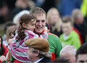 27 October 2013; Rathnew captain Peter Dignam gets a hug from his niece, eight year old, Anna Dignam on his way up to receive the cup. Wicklow County Senior Club Football Championship Final, Baltinglass v Rathnew, County Grounds, Aughrim, Co. Wicklow. Picture credit: Matt Browne / SPORTSFILE