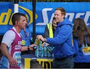 28 October 2013; Kerry footballer Colm Cooper surprised marathon runners today when he linked up with Lucozade Sport at the “Wall of Support” at the Airtricity Dublin Marathon. The Wall was located at the 20th mile at Roebuck Road, designed to help people through the infamous ‘wall’. The Wall of Support carried good luck messages from friends and family of people taking part in the marathon and Colm Cooper came along to hand out some much needed Lucozade Sport and to show his support for the thousands of runners, joggers and walkers. Pictured is Kerry footballer Colm Cooper handing out a bottle of Lucozade Sport to Gordon Linton, Maghera, during the Airtricity Dublin Marathon 2013. Roebuck Road, Dublin. Picture credit: Ramsey Cardy / SPORTSFILE
