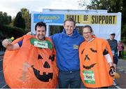 28 October 2013; Kerry footballer Colm Cooper surprised marathon runners today when he linked up with Lucozade Sport at the “Wall of Support” at the Airtricity Dublin Marathon. The Wall was located at the 20th mile at Roebuck Road, designed to help people through the infamous ‘wall’. The Wall of Support carried good luck messages from friends and family of people taking part in the marathon and Colm Cooper came along to hand out some much needed Lucozade Sport and to show his support for the thousands of runners, joggers and walkers. Pictured is Kerry footballer Colm Cooper with competitors Alastair McDonald, and Claire Spencer, London, England, during the Airtricity Dublin Marathon 2013. Roebuck Road, Dublin. Picture credit: Ramsey Cardy / SPORTSFILE