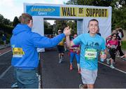 28 October 2013; Kerry footballer Colm Cooper surprised marathon runners today when he linked up with Lucozade Sport at the “Wall of Support” at the Airtricity Dublin Marathon. The Wall was located at the 20th mile at Roebuck Road, designed to help people through the infamous ‘wall’. The Wall of Support carried good luck messages from friends and family of people taking part in the marathon and Colm Cooper came along to hand out some much needed Lucozade Sport and to show his support for the thousands of runners, joggers and walkers. Pictured is Kerry footballer Colm Cooper handing out a bottle of Lucozade Sport to David Nolan, Tallaght, during the Airtricity Dublin Marathon 2013. Roebuck Road, Dublin. Picture credit: Ramsey Cardy / SPORTSFILE