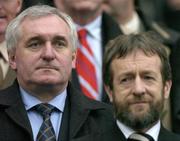 24 October 2004; An Taoiseach Bertie Ahern TD, standing behind President of the GAA Sean Kelly. Coca Cola International Rules Series 2004, Second Test, Ireland v Australia, Croke Park, Dublin. Picture credit; Brendan Moran / SPORTSFILE *** Local Caption *** Any photograph taken by SPORTSFILE during, or in connection with, the 2004 Coca Cola International Rules Series which displays GAA logos or contains an image or part of an image of any GAA intellectual property, or, which contains images of a GAA player/players in their playing uniforms, may only be used for editorial and non-advertising purposes.  Use of photographs for advertising, as posters or for purchase separately is strictly prohibited unless prior written approval has been obtained from the Gaelic Athletic Association.