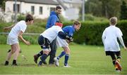 30 October 2013; Participant Joost Peeters is tackled by Darren Magee as St Mary's RFC CCRO Darragh O'Kelly looks on during a Leinster School of Excellence. Leinster School of Excellence on Tour in Railway Union RFC, Dublin. Picture credit: Brendan Moran / SPORTSFILE