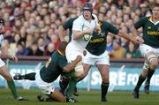 13 November 2004; Paul O'Connell, Ireland, is tackled by Eddie Andrews, South Africa. Rugby International, Ireland v South Africa, Lansdowne Road, Dublin. Picture credit; Matt Browne / SPORTSFILE
