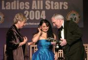 20 November 2004; Christina Reilly of Monaghan listens to some advice from An Taoiseach Bertie Ahern TD, in the company of President of the Ladies Football Association Geraldine Giles, as she receives her Ladies Football All-Star award at the O'Neills / TG4 Ladies Football All-Stars. Citywest, Dublin. Picture credit; Brendan Moran / SPORTSFILE