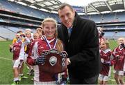 5 November 2013; Holy Family S.N.S., Swords, Co. Dublin, captain Robyn Lynch, receives the winning trophy from former Dublin footballer Ciaran Whelan after the game. Allianz Cumann na mBunscol Football Finals, Croke Park, Dublin. Picture credit: Barry Cregg / SPORTSFILE