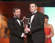 26 November 2004; Niall McCarthy of Cork, is presented with his Allstar award by Sean Kelly, President of the GAA, at the 2004 Vodafone GAA All-Star Awards. Citywest, Dublin. Picture credit; Brendan Moran / SPORTSFILE