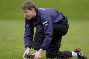 30 November 2004; Ronan O'Gara ties his laces before Munster rugby squad training. University of Limerick, Limerick. Picture credit; Damien Eagers / SPORTSFILE